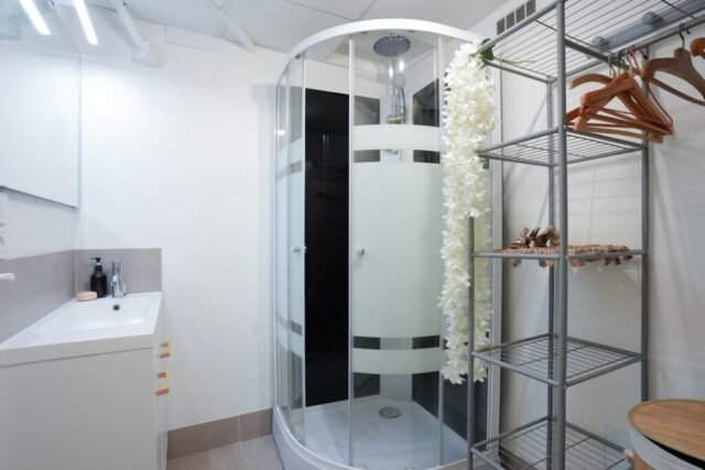 Salle d'eau du dortoir avec cabine de douche, vasque et penderie Salle d'eau du dortoir avec cabine de douche, vasque et penderie